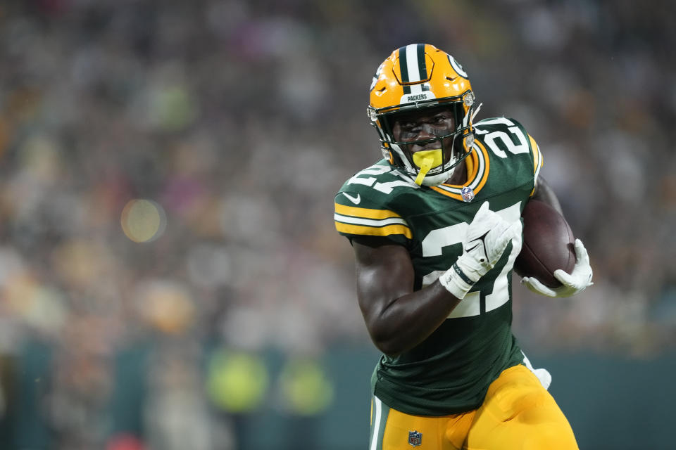 GREEN BAY, WISCONSIN – AUGUST 19: Patrick Taylor #27 of the Green Bay Packers runs for an 8-yard touchdown in the second quarter against the <a class="link " href="https://sports.yahoo.com/nfl/teams/new-england/" data-i13n="sec:content-canvas;subsec:anchor_text;elm:context_link" data-ylk="slk:New England Patriots;sec:content-canvas;subsec:anchor_text;elm:context_link;itc:0">New England Patriots</a> during a preseason game at Lambeau Field on August 19, 2023 in Green Bay, Wisconsin. (Photo by Patrick McDermott/Getty Images)