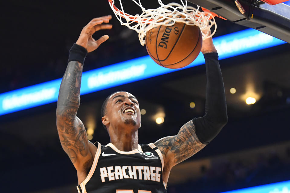 Atlanta Hawks forward John Collins dunks against the Detroit Pistons during the first half of an NBA basketball game Saturday, Jan. 18, 2020, in Atlanta. (AP Photo/John Amis)