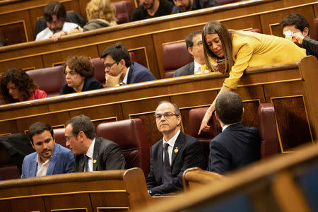 Jailed Catalan politicians Josep Rull, Jordi Turull and Jordi Sanchez attend the first session of parliament following a general election in Madrid, Spain, May 21, 2019. Bernat Armangue/Pool via REUTERS