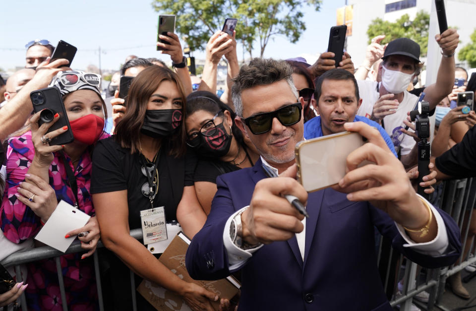 FILE - Alejandro Sanz shoots a selfie photo with fans following a ceremony to award him a star on the Hollywood Walk of Fame on Oct. 1, 2021, in Los Angeles. Sanz turns 54 on Dec. 18. (AP Photo/Chris Pizzello, File)