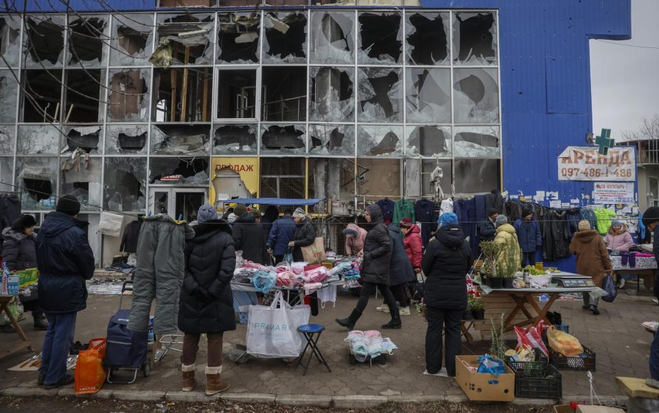 Mandatory Credit: Photo by SERGEI ILNITSKY/EPA-EFE/Shutterstock (13660738o) Local residents gather at an outdoor market in Mariupoll, Ukraine, 10 December 2022 (issued 11 December 2022). An estimate 250,000 inhabitants have left the city, about 300,000 still remain. During the hostilities, up to 70 percent of the housing stock of Mariupol was destroyed and about 5,000 civilians were killed due to fighting and shelling, Konstantin Ivashchenko, the new mayor of the city, said. City authorities prepare residential buildings for winter and change all central heating systems in Mariupol, where by the end of the year at least 1,000 residential buildings, social and cultural facilities will be connected to heat, said Russian Deputy Prime Minister Marat Khusnullin. The government of the self-proclaimed Donetsk People's Republic (DPR) reported that 129,000 square meters of new housing will appear next year in Mariupol. More than 5,000 builders are working on the restoration of the city. Mariupol is expected to be completely rebuilt in three years. Self-proclaimed DPR expects Mariupol completely rebuilt in three years, Ukraine - 10 Dec 2022 - SERGEI ILNITSKY/EPA-EFE/Shutterstock