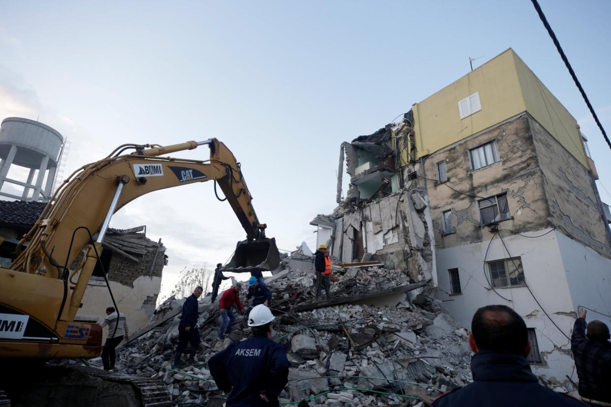 Emergency personnel work near a damaged building in Thumane, after an earthquake shook Albania: Reuters