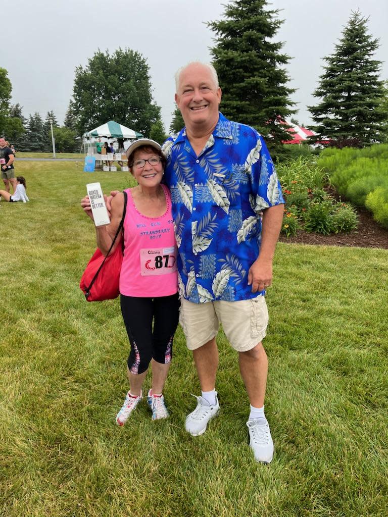 Participant Linda McAteer-Palmer of Kohler, wearing a shirt that reads 'Will Run for Strawberry Soup,' with Acuity Executive Chef Mike Luedke, who is renowned for his culinary creation.