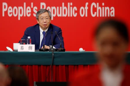 FILE PHOTO: Governor of People's Bank of China (PBOC) Yi Gang attends a news conference on China's economic development ahead of the 70th anniversary of its founding, in Beijing