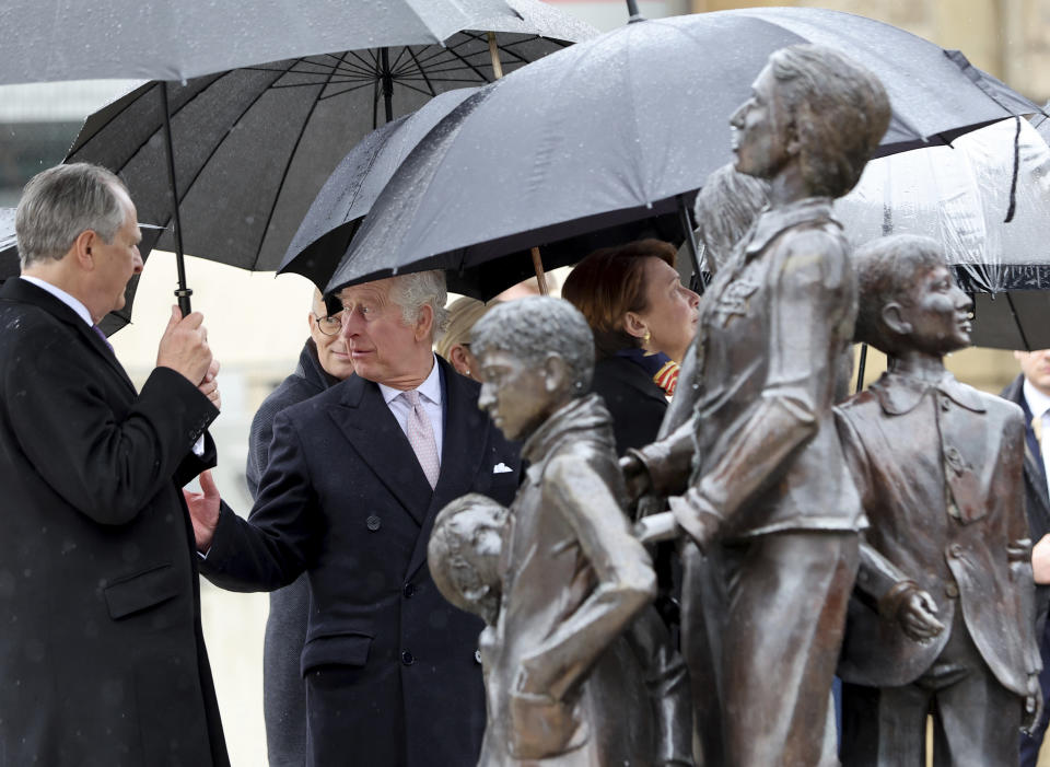Britain's King Charles III visits to the memorial "Kindertransport - Der letzte Abschied" (Children's Transport - The Last Farewell) at Dammtor station in Hamburg, Germany, Friday, March 31, 2023. The bronze sculpture commemorates predominantly Jewish children who were sent to Great Britain during the Nazi era and mostly never saw their relatives who stayed behind again. (Jens Buettner/dpa via AP)