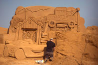 <p>A sand carver works on a sculpture during the Sand Sculpture Festival “Disney Sand Magic” in Ostend, Belgium. (Photo courtesy of Disneyland Paris) </p>