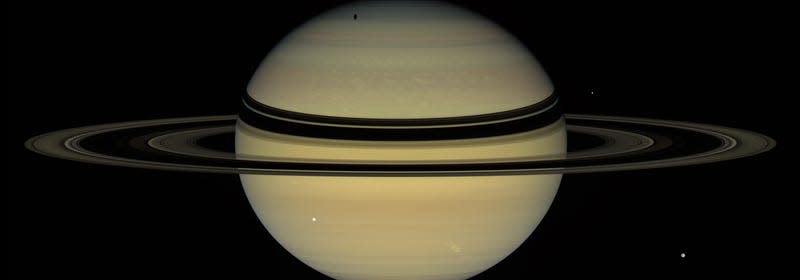 A view from NASA’s Cassini spacecraft, December 6, 2007. Three moons are visible.
