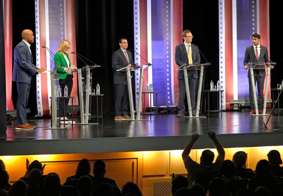 The audience cheers as candidates speak, from left, Lt. Gov. Mandela Barnes, state Treasurer Sarah Godlewski, Milwaukee Bucks executive Alex Lasry, Outagamie County Executive Tom Nelson and nonprofit executive Steven Olikara during the Democratic U.S. Senate debate at Marquette University's Varsity Theatre in Milwaukee on Sunday, July 17, 2022. It was the first televised debate of Wisconsin's campaign season before the Aug. 9 primary.