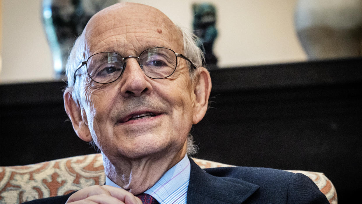 Supreme Court Justice Stephen Breyer sits in a chair during an interview.