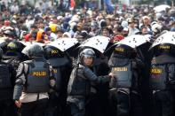 Riot police officers are seen during a protest against the government's labor reforms in "jobs creation" bill in Jakarta