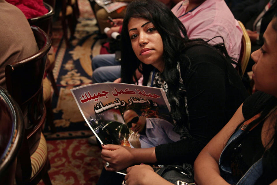 FILE - In this Monday, Sept. 30, 2013 file photo, a supporter of Defense Minister Gen. Abdel-Fattah el-Sissi holds a poster bearing photo of him and Arabic that reads, "continue your duties and choose your president, campaign," during a campaign to collect signatures and nominate el-Sissi to run for Egypt's president at Pyramisa hotel in Cairo, Egypt. Egypt's military chief is looking for a strong turnout in next week's nationwide constitutional referendum as a mandate on whether he should run for president, senior officials tell the AP. The popular general who ousted President Mohammed Morsi and ordered a crackdown on the Muslim Brotherhood could be disappointed as his Islamist foes have promised a boycott and mass demonstrations raising fears of violence that are likely to keep voters at home. (AP Photo/Nariman El-Mofty, File)