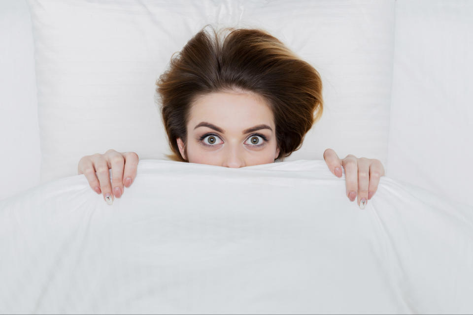 Person peeking over a blanket with wide eyes, possibly related to a surprising or indulgent food concept