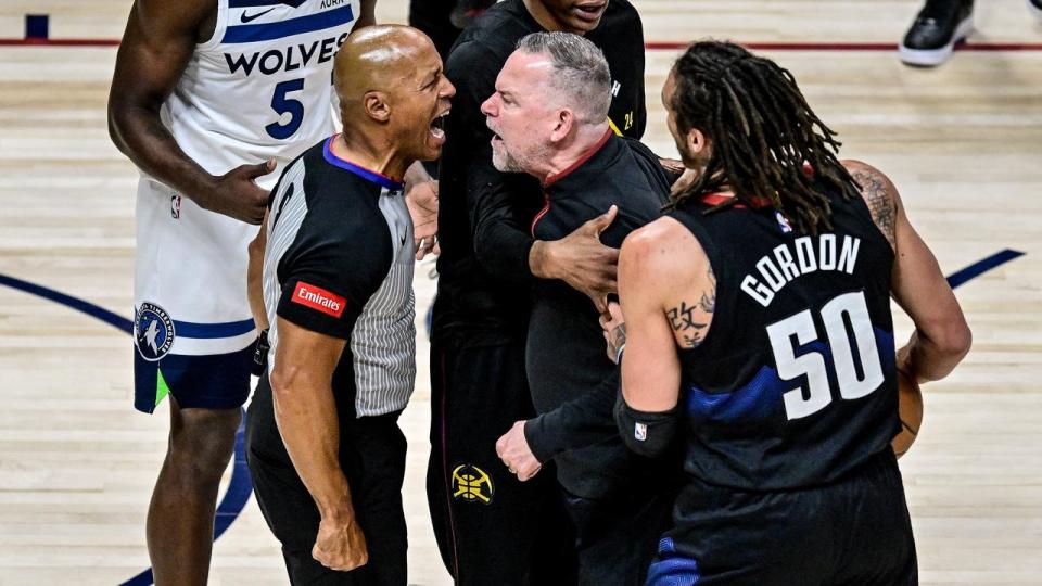 Denver coach Michael Malone argues with referee Marc Davis.