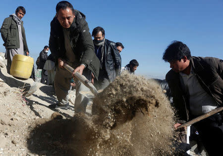 Afghan Shi'ite Muslim take part in a burial ceremony of one of the victims, which was killed during yesterday's suicide attack at a Shi'ite cultural centre in Kabul, Afghanistan December 29, 2017. REUTERS/Omar Sobhani