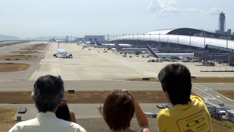 Visitors to the rooftop deck at Kansai International Airport look at the jetliners on the runway in Izumisano, Osaka prefecture, Japan, Sept. 6, 2000. The airport says it has never lost a piece of luggage since it first opened in 1994.
