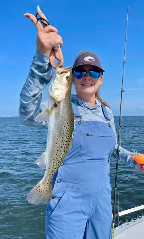 Cyndi Lanier from KCsportfishing hold up her catch while fishing with Captain Jordon Todd of Saltwater Obsession Charters in St. Joe Bay.