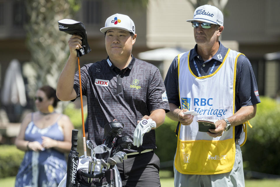 Sungjae Im, left, of South Korea, and his caddie plan his shot off the third tee during the final round of the RBC Heritage golf tournament, Sunday, April 16, 2023, in Hilton Head Island, S.C. (AP Photo/Stephen B. Morton)