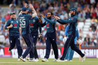 Cricket - England v India - Third One Day International - Emerald Headingley, Headingley, Britain - July 17, 2018 England's Adil Rashid with team mates celebrate taking the wicket of India's Suresh Raina Action Images via Reuters/Ed Sykes