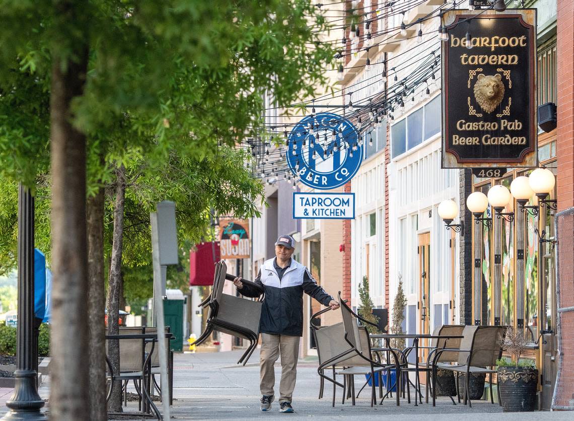 Cesare Mammarella, owner of Bearfoot Tavern, puts out chairs in front of the restaurant on 2nd Street Wednesday morning. Mammarella decided to open the dining room starting Wednesday after being closed over 5 weeks during the COVID-19 pandemic. Jason Vorhees/jvorhees@macon.com