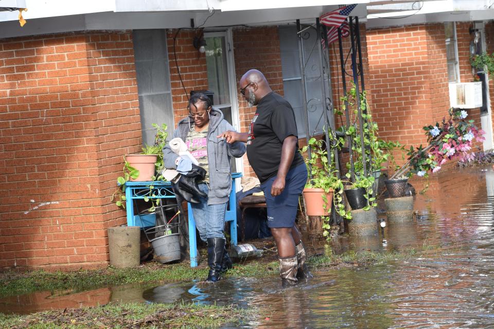 Stephen Chark, right, helps Carrie Smith as she leaves her home on 14th Street off Willow Glen Road in Alexandria, Louisiana. Saturday, Oct. 10, 2020. Hurricane Delta dumped heavy rains in the area flooding most streets and houses off Willow Glen.