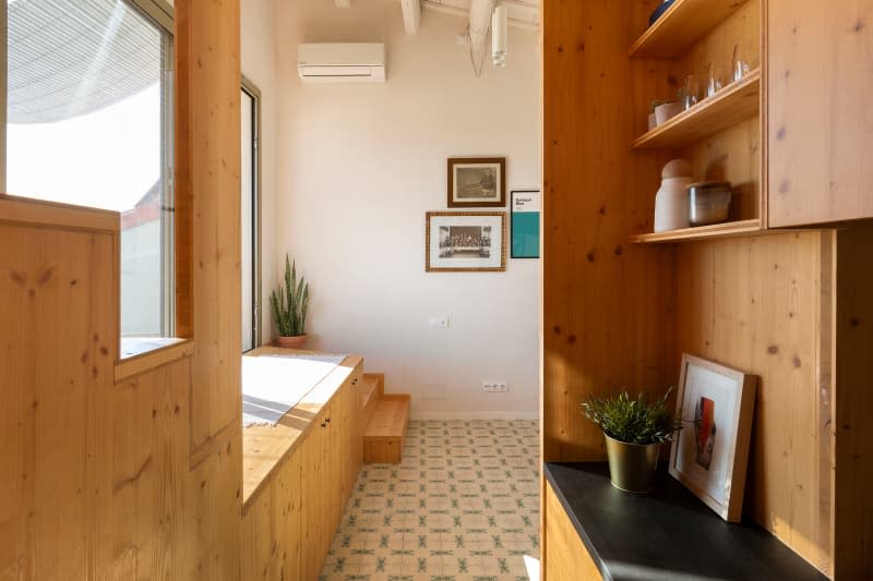 white apartment with lots of wood and tile floor. view from hall/stairs area