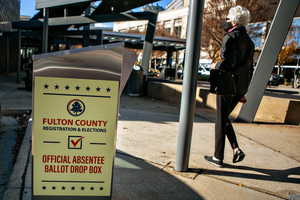 A voter arrives at the Buckhead library in Atlanta on the first day of In-person early voting for the Georgia Senate runoff election. (Jason Armond / Los Angeles Times via Getty Images)                     