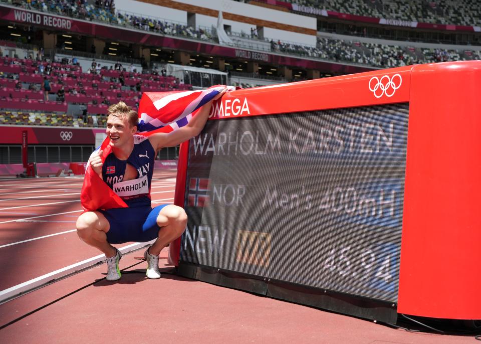 Karsten Warholm celebrates his world record in the men's 400-meter hurdles.