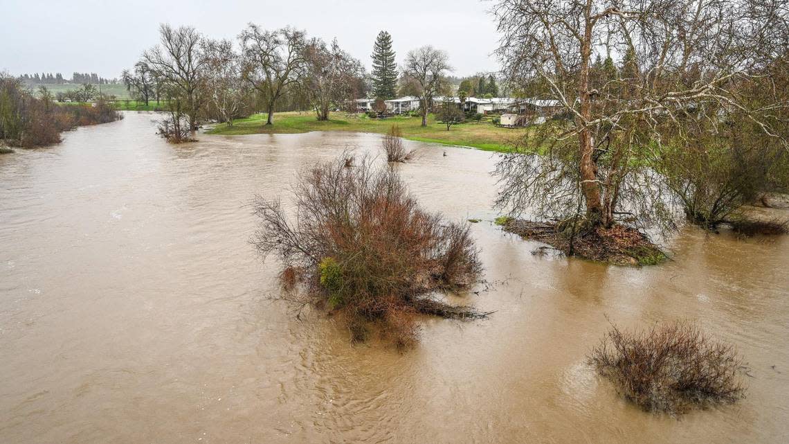 San Joaquin River water creeps toward mobile homes near Highway 41 in north Fresno as rain continues during an atmospheric river event on Saturday, Jan. 14, 2023.