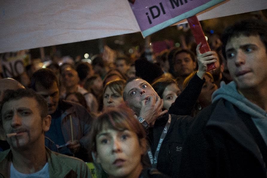 Protestors gather near Parliament demonstrating against austerity measures announced by the Spanish government in Madrid, Spain, Saturday, Sept. 29, 2012. Tens of thousands of Spaniards and Portuguese rallied in the streets to protest enduring deep economic pain from austerity cuts. In Madrid, demonstrators approached parliament for the third time this week to vent their anger against tax hikes, government spending cuts and the highest unemployment rate among the 17 nations that use the euro(AP Photo/Daniel Ochoa De Olza)