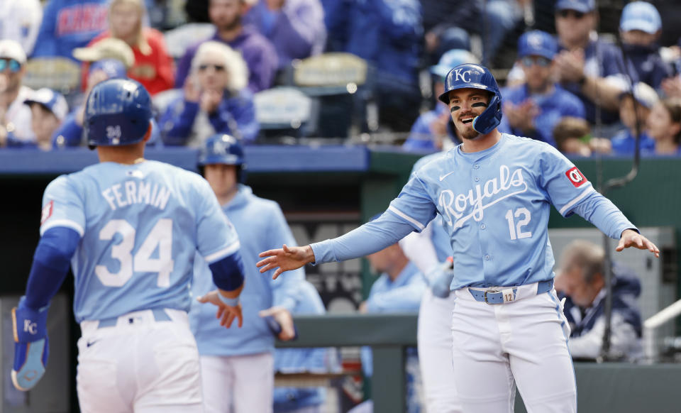 Kansas City Royals' Nick Loftin (12) reacts as Freddy Fermin (34) scores off a hit by Maikel Garcia during the first inning of a baseball game against the Houston Astros in Kansas City, Mo., Thursday, April 11, 2024. (AP Photo/Colin E. Braley)