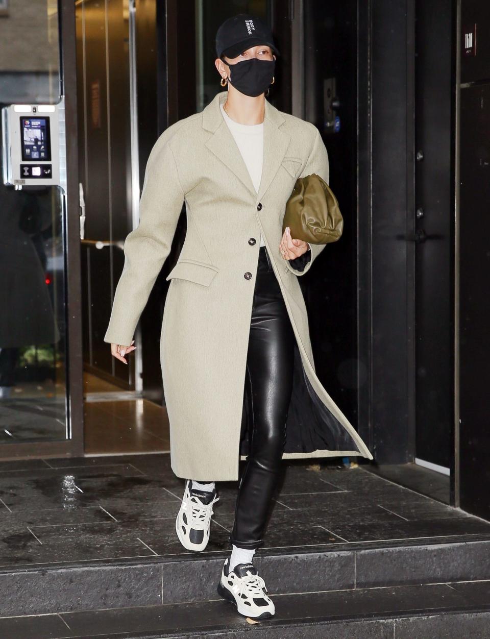 <p>Hailey Bieber steps out in a baseball cap, a long coat and sneakers on Monday morning to start her day in N.Y.C.</p>