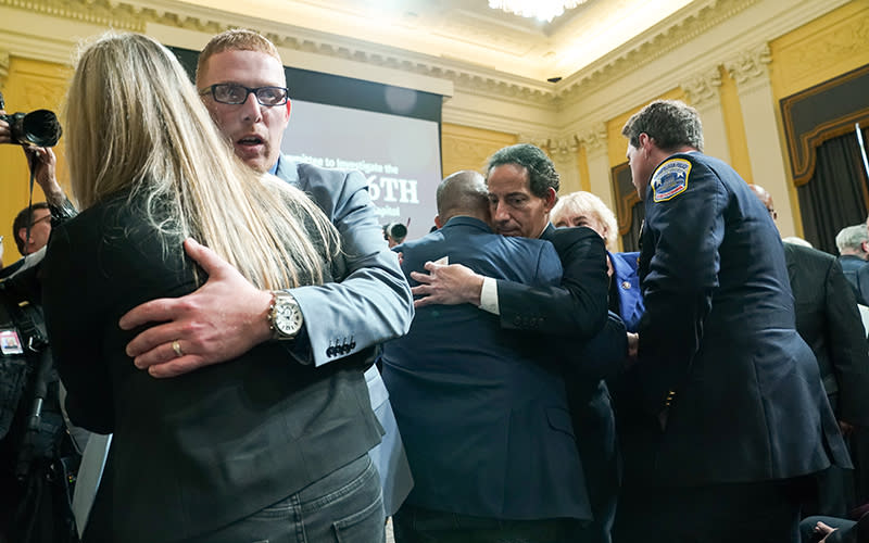 People hug after a House committee hearing on the Jan. 6, 2021, Capitol riot