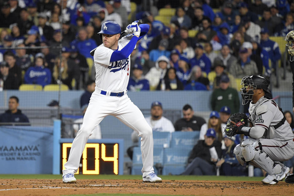 Los Angeles Dodgers' Freddie Freeman, left, stands at bat as Arizona Diamondbacks catcher Gabriel Moreno kneels behind the plate as the pitch clock runs down during the third inning of an opening day baseball game Thursday, March 30, 2023, in Los Angeles. (AP Photo/Mark J. Terrill)