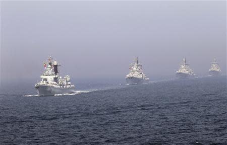 Chinese missile destroyers navigate during the fleet's review of the China-Russia joint naval exercise in the Yellow Sea in this April 26, 2012 file photo. REUTERS/Stringer/Files