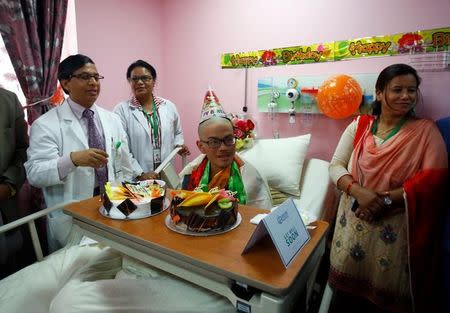 Taiwanese hiker Liang Sheng Yueh, who was lost in the Himalayas for over a month, celebrates his 21st birthday at a hospital after being rescued, in Kathmandu, Nepal April 28, 2017. REUTERS/Navesh Chitrakar