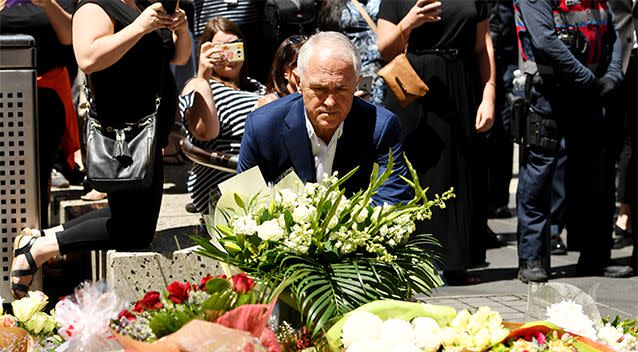 Prime Minister Malcolm Turnbull lays flowers at a floral tribute on Bourke Street, Melbournem on January 22. Photo: AAP