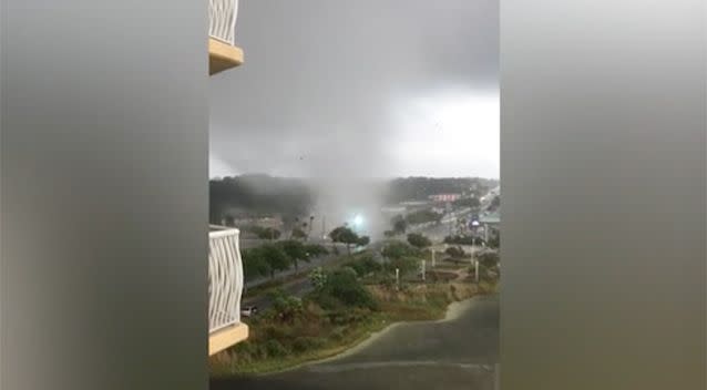 The funnel cloud barrels directly into powerlines. Source: Dave Perkins/ Facebok