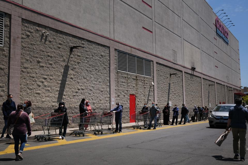 People wait in line outside of a Costco in Brooklyn on May 14, 2020 in New York City. With a limited number of stores open in New York and the new social distancing requirements, many supermarkets are still seeing long lines.