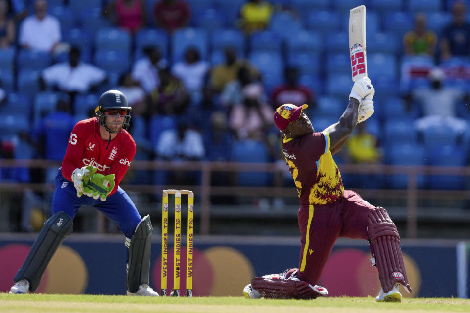West Indies' captain Rovman Powell hits a six from a delivery of England's Liam Livingstone during the third T20 cricket match at National Cricket Stadium in Saint George's, Grenada, Saturday, Dec. 16, 2023. (AP Photo/Ricardo Mazalan)