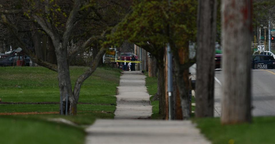 A heavy police presence and crime scene tape near West Holmes Road and Simken Drive in Lansing, Wednesday, April 120, 2024.