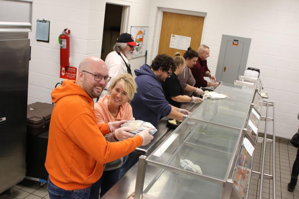 Spenser Benefield and Lori Groll joined over 50 volunteers, in passing out 600 free Thanksgiving dinners. Dinners were prepared by Carolyn's Personalized Catering in Millbury.The 14th annual event was a drive-thru, held at Woodmore High School on Thanksgiving. 