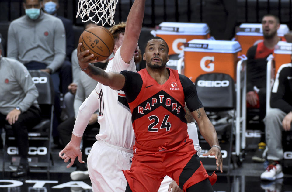 Toronto Raptors guard Norman Powell, right, drives to the basket against Portland Trail Blazers center Jusuf Nurkic, left, during the first half of an NBA basketball game in Portland, Ore., Monday, Jan. 11, 2021. (AP Photo/Steve Dykes)