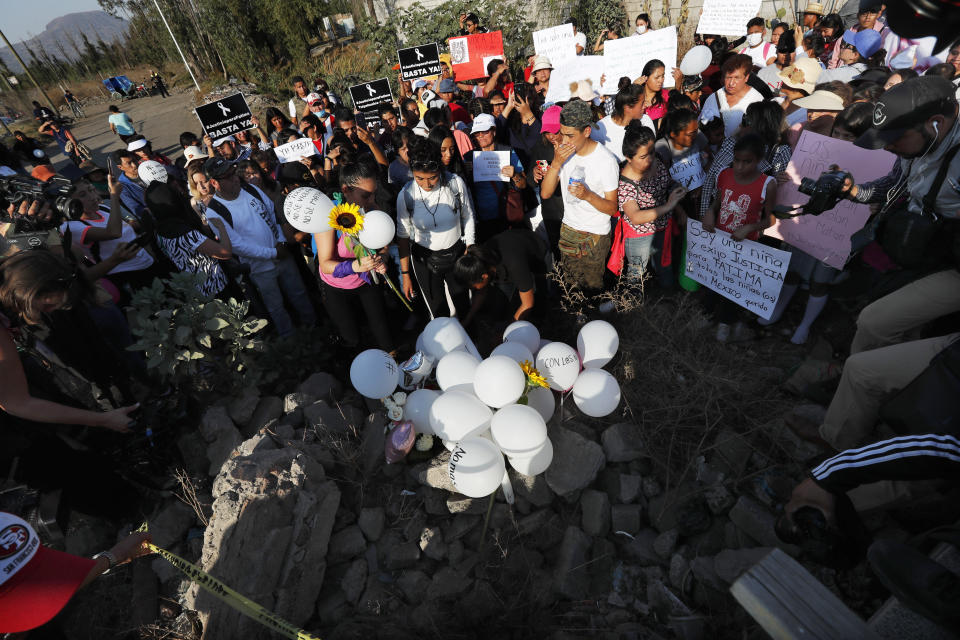 Demonstrators set a up a memorial with flowers, balloons and candles at the site where the body of Fatima, a 7-year-old girl who was abducted from the entrance of the Enrique C. Rebsamen primary school and later murdered, was found in Mexico City, Monday, Feb. 17, 2020. The girl’s body was found wrapped in a bag and abandoned in a rural area on Saturday and was identified by genetic testing. (AP Photo/Marco Ugarte)