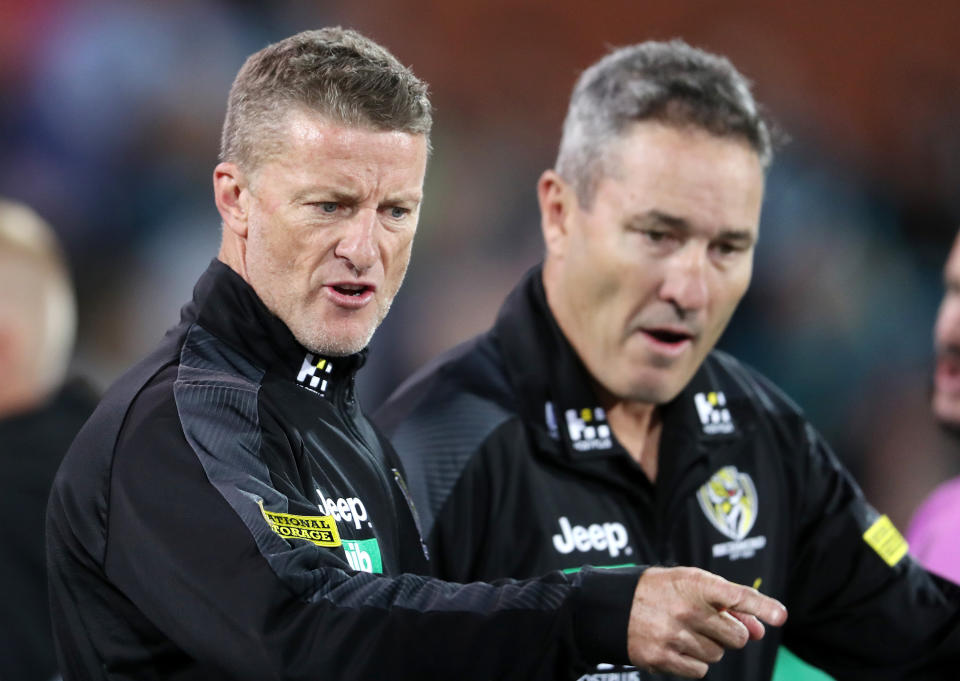 Richmond coach Damien Hardwick points and speaks to his players in Adelaide, Australia.