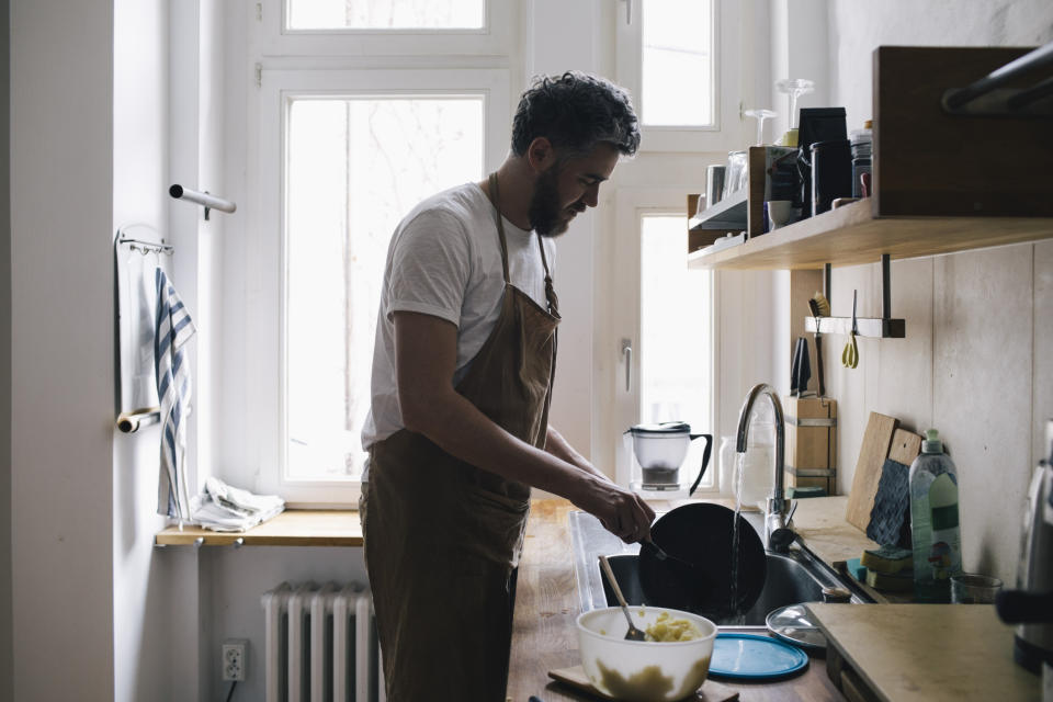 A man is washing the dishes