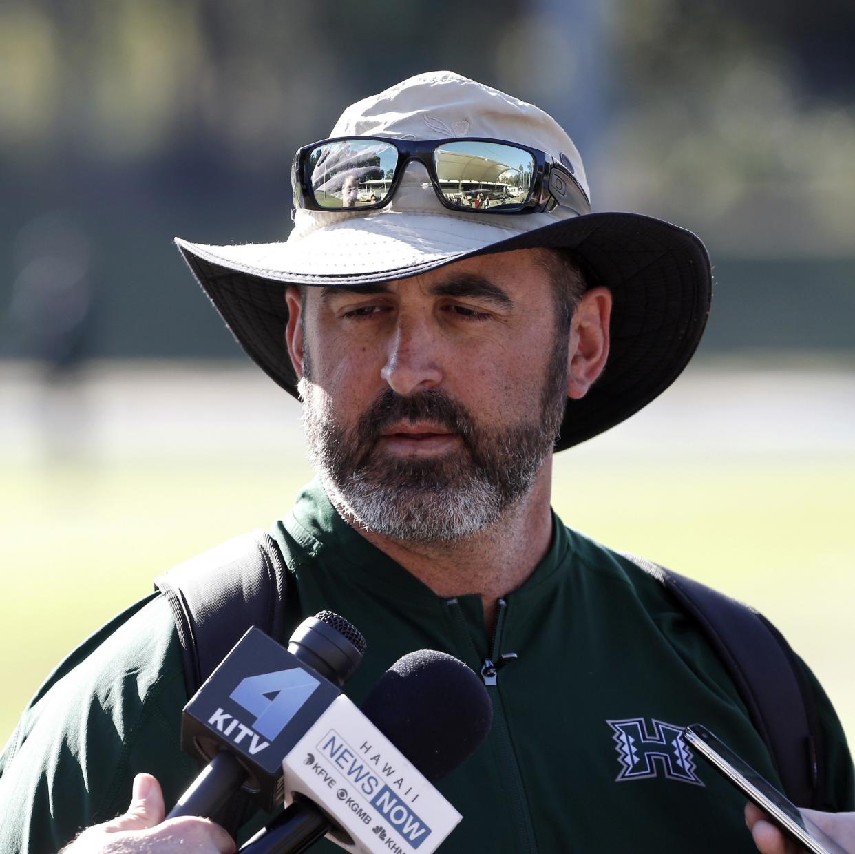 Hawaii Rainbow Warriors' coach Nick Rolovich speaks to media during a training run at a field in Sydney, Australia, Friday, Aug. 26, 2016. (AP Photo/Rob Griffith)