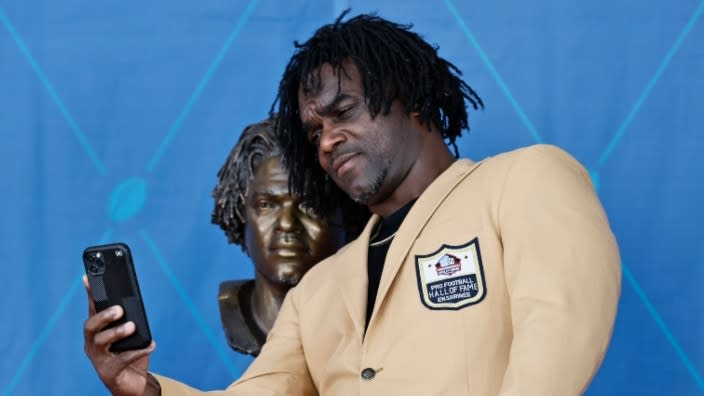 Former NFL player Edgerrin James takes a selfie with his bust during the induction ceremonies at the Pro Football Hall of Fame on Saturday in Canton, Ohio. (Photo by Ron Schwane-Pool/Getty Images)