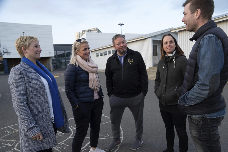 This photo taken Friday 15, June, 2019 shows Linda Hilmarsdottir, Josep Gunnarsson, Marta Sigurjonsdottir, Heidar Atlason, Elsba Danjalsdottir who are part of the "Parent Patrol" in the Korar neighborhood of Reykjavik. Parent patrols to check out the usual youth hangouts form part of the Icelandic strategy to turn around a crisis in teenage drinking and smoking, and it has been so successful that Iceland has one of the lowest rates of youth substance abuse in Europe.(AP Photo/Egill Bjarnason)