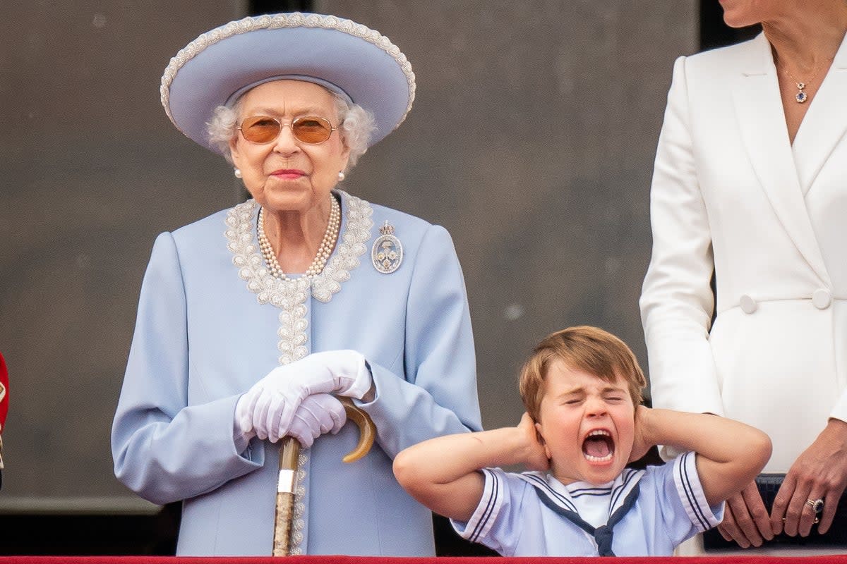 The Queen with Prince Louis as he pulls a face on the balcony of Buckingham Palace (Aaron Chown/PA) (PA Wire)
