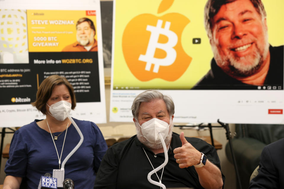 BURLINGAME, CALIFORNIA - JULY 23: Apple co-founder Steve Wozniak (R) gives the thumbs-up as he speaks during a press conference with his wife Janet Wozniak (L) on July 23, 2020 in Burlingame, California. Steve Wozniak and 17 other victims are filing a lawsuit against YouTube and Google over their lack of action to address a fraudulent Bitcoin giveaway that used an image of Wozniak to to defraud innocent people out of their cryptocurrency. (Photo by Justin Sullivan/Getty Images)